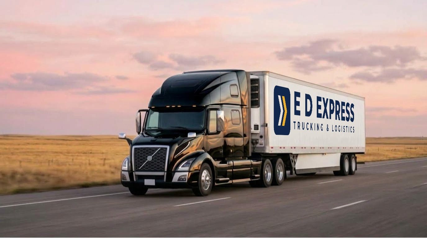 E D Express truck pulling a lettered reefer trailer across open country at dusk